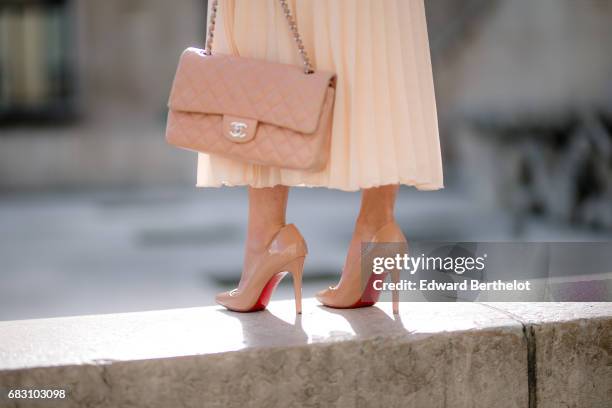 May Berthelot, fashion blogger and Head of Legal at Videdressing.com, wears an Asos white ruffled top, an Asos pleated pink skirt, Louboutin Pigalle...