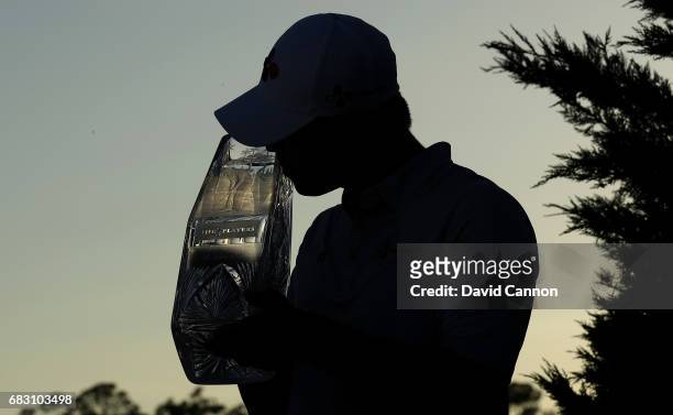 Si Woo Kim of South Korea holds the trophy after his win in the final round of the THE PLAYERS Championship on the Stadium Course at TPC Sawgrass on...