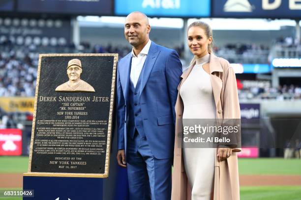 Derek Jeter poses with his Wife Hannah Davis during the retirement ceremony of his number 2 jersey at Yankee Stadium on May 14, 2017 in New York City.