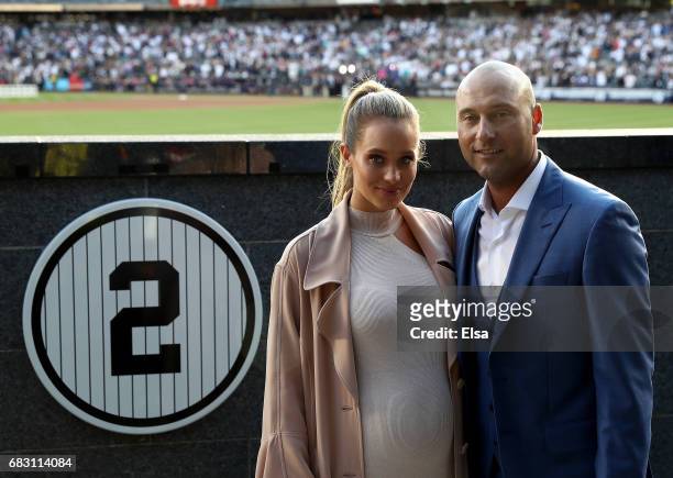 Hannah Jeter and Derek Jeter pose next to his number in Monument Park at Yankee Stadium during the retirement cerremony of Jeter's jersey at Yankee...