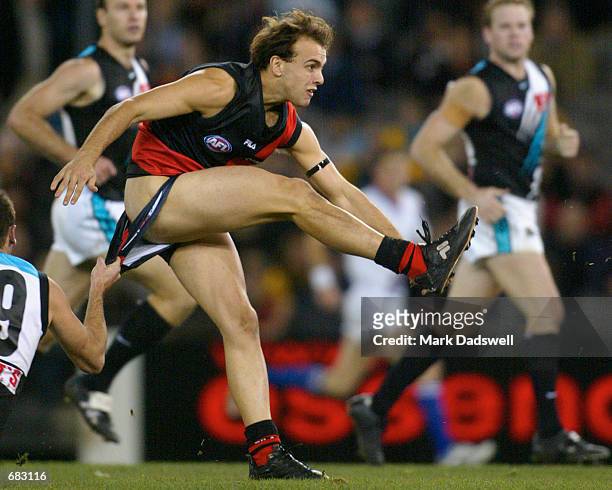Adam Ramanauskas for the Bombers almost loses his shorts in a tackle by Matthew Bishop for Port Adelaide during the Round 11 Essendon Bombers versus...