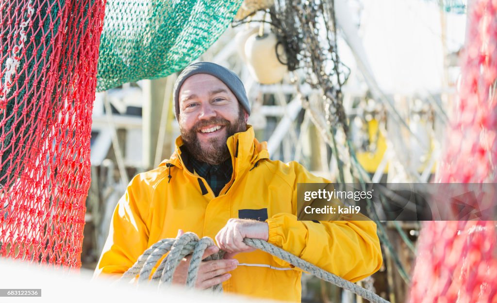 Man working on commercial fishing vessel