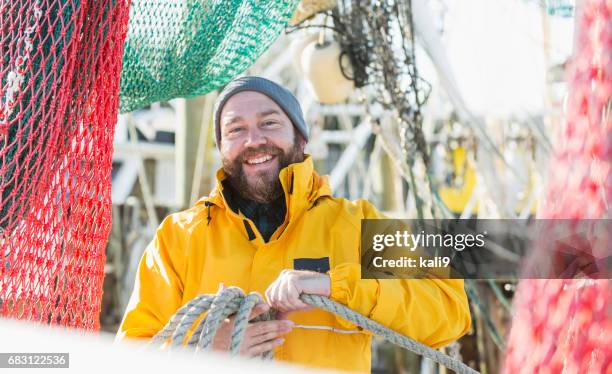 man working on commercial fishing vessel - fisher man imagens e fotografias de stock