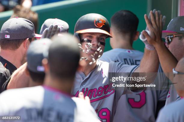 Baltimore Orioles first baseman Chris Davis has sunflower seeds thrown at hi in celebration after hitting a home run during the MLB game between the...