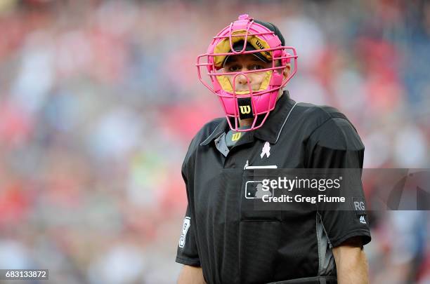 Home plate umpire Andy Fletcher wears a pink mask for mother's day in the first inning of the game between the Washington Nationals and the...