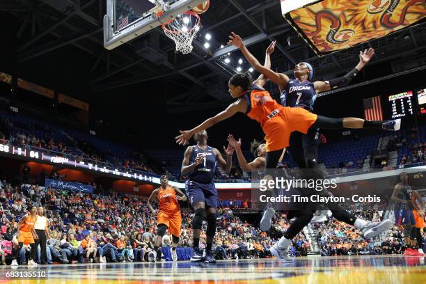 May 13: Guard Jasmine Thomas of the Connecticut Sun commits an offensive foul on guard Brianna Kiesel of the Atlanta Dream as she drives to the...