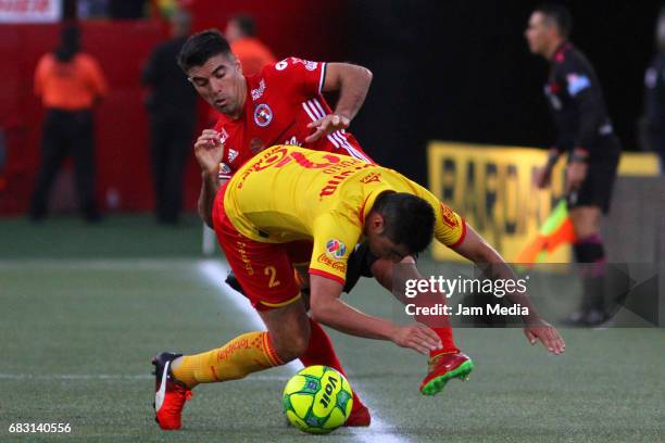Enrique Perez of Morelia and Victor Malcorra of Tijuana fight for the ball during the quarter finals second leg match between Tijuana and Morelia as...