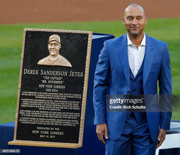 Former New York Yankees great, Derek Jeter stands by his plaque during a pregame ceremony honoring Jeter and retiring his number 2 at Yankee Stadium...