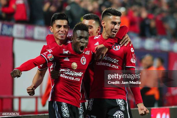 Juan Lucero of Tijuana celebrates with teammates after scoring his team's second goal during the quarter finals second leg match between Tijuana and...