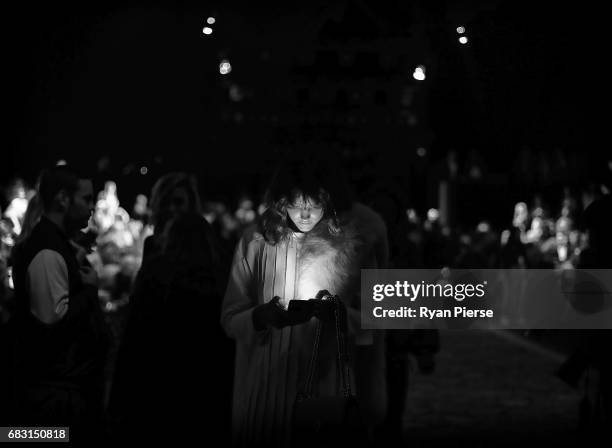 Model Montana Cox checks her phone at the Alice McCall show the during Mercedes-Benz Fashion Week Resort 18 Collections at Carriageworks on May 15,...