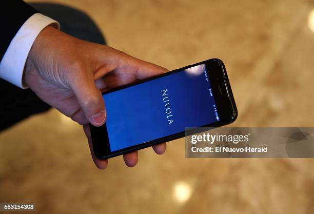 Juan Carlos Abello, displays his Nuvola app on his phone. His company is geared to both employees of and guests of hotels, on April 20 in Doral, Fla.