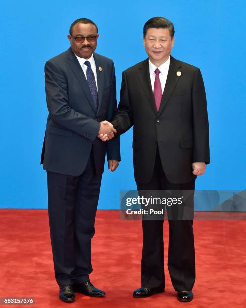 Ethiopia's Prime Minister Hailemariam Desalegn shakes hands with Chinese President Xi Jinping during the welcome ceremony for the Belt and Road...