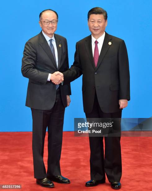World Bank Group President Jim Yong Kim shakes hands with Chinese President Xi Jinping during the welcome ceremony for the Belt and Road Forum, at...
