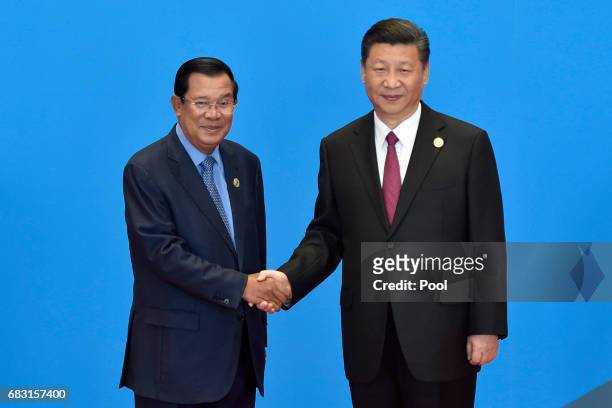 Cambodian Prime Minister Hun Sen shakes hands with Chinese President Xi Jinping during the welcome ceremony for the Belt and Road Forum, at the...