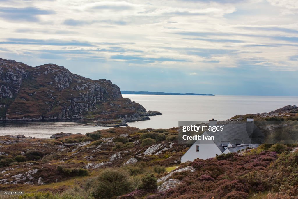 Scotland crofters cottage in dramatic Highland mountain glen panorama