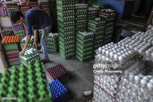 Worker arranges eggs in a wholesale store at Crawford Market in Mumbai, India, on Saturday, May 13, 2017. A Goods and Services Tax for India will in...