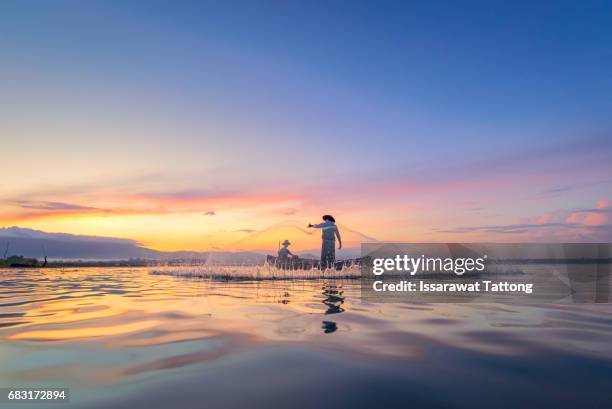 fishermen fishing in the early morning golden light - freshwater fishing stock pictures, royalty-free photos & images