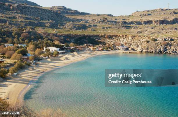 view over main beach from acropolis of lindos. - lindos stock pictures, royalty-free photos & images