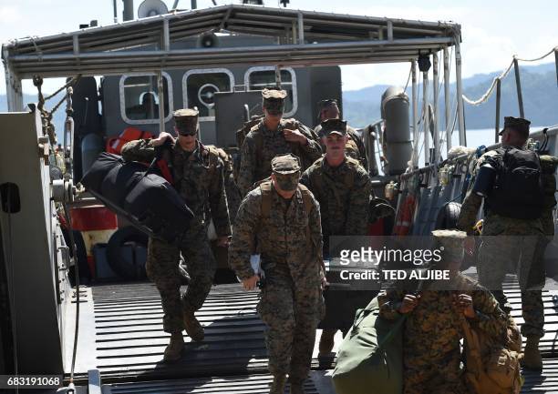 Marines disembark from a Philippine navy landing ship during a simulation of a disaster drill as part of the annual joint Philippines-US military...