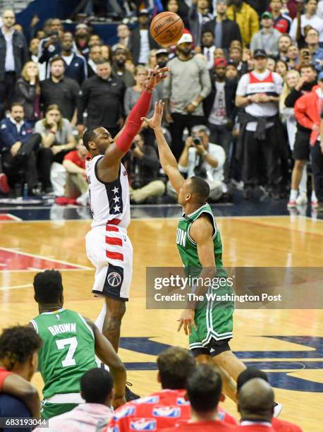 Washington Wizards guard John Wall nails the game winning three pointer over Boston Celtics guard Avery Bradley during game six of the Eastern...