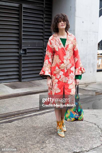 Fashion Stylist Chloe Hill is wearing a Tome cost, Romance was Born and Beau Coups boots and a vintage bag during Mercedes-Benz Fashion Week Resort...