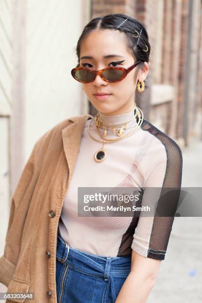 Fashion Blogger Tara Chandra is wearing Pageants top, Quinn Hamlen skirt and vintage Wranger jacket during Mercedes-Benz Fashion Week Resort 18...