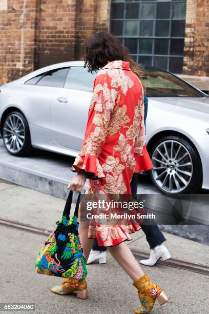 Fashion Stylist Chloe Hill is wearing a Tome cost, Romance was Born and Beau Coups boots and a vintage bag during Mercedes-Benz Fashion Week Resort...