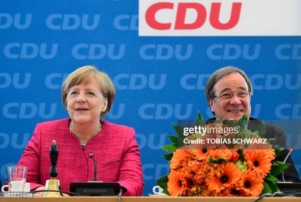 German Chancellor Angela Merkel and Armin Laschet, top candidate of their conservative Chrisitan Democratic Union party for regional elections in the...