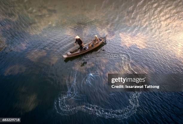 fishermen fishing in the early morning golden light - thai china stock pictures, royalty-free photos & images