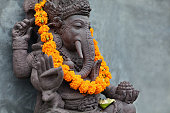 Ganesha with balinese Barong masks, flowers necklace and ceremonial offering