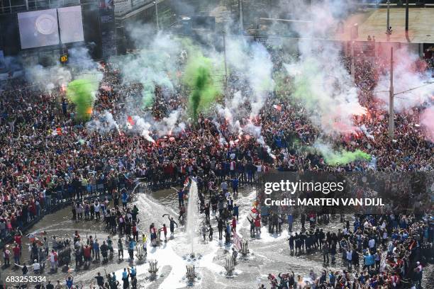 Fans of Feyenoord Rotterdam football club gather near the fountain at the Hofplein in Rotterdam, on May 15, 2017 prior to the celebrations for...