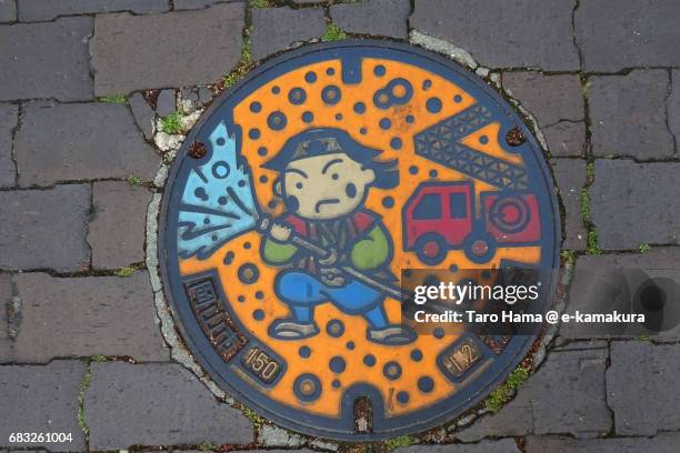 manhole cover in okayama city - マンホール ストックフォトと画像