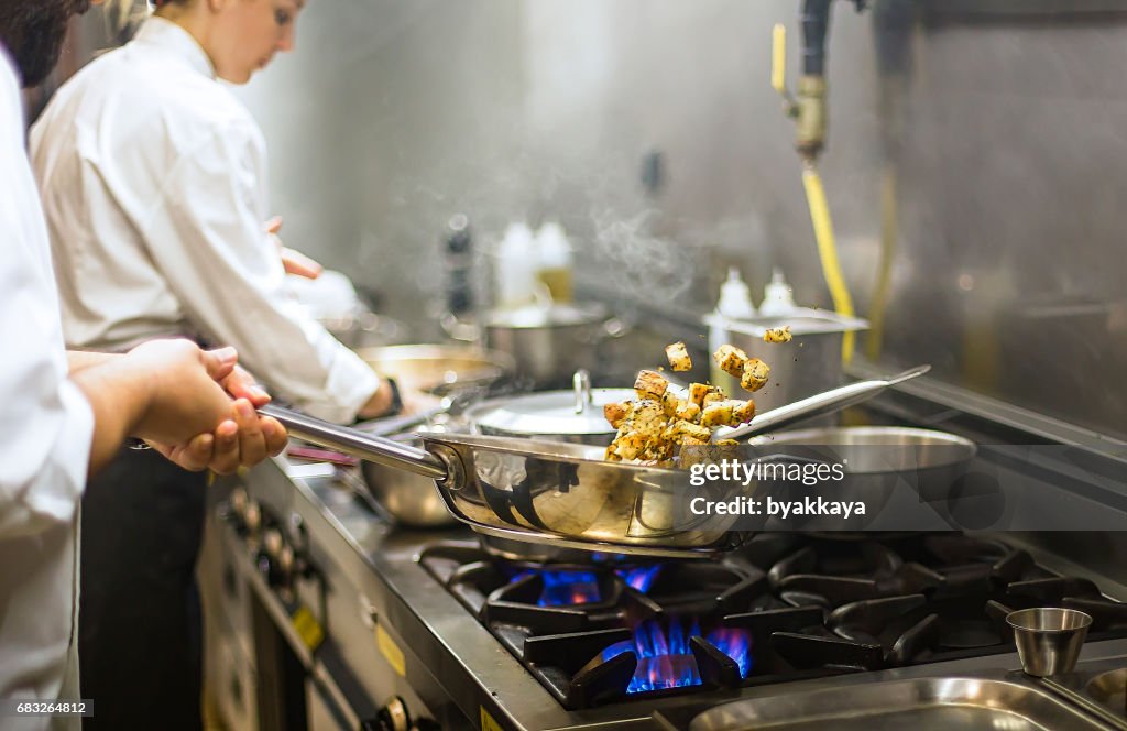 Chef preparing cuisine in hotel kitchen