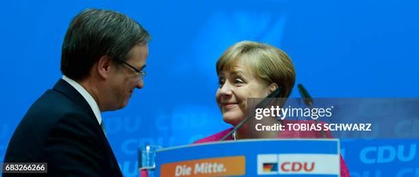 German Chancellor Angela Merkel and Armin Laschet, top candidate of their conservative Christian Democratic Union party for regional elections in the...