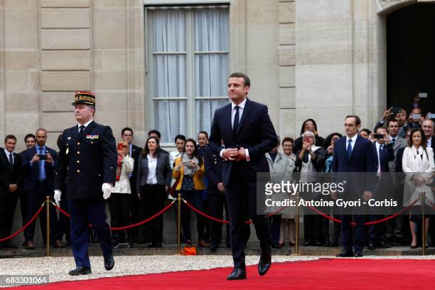 French newly elected President Emmanuel Macron is welcomed by his predecessor Francois Hollande as he arrives at the Elysee presidential Palace for...