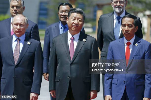 Chinese President Xi Jinping and Russian President Vladimir Putin take a commemorative photo along with other leaders and delegates at the Belt and...