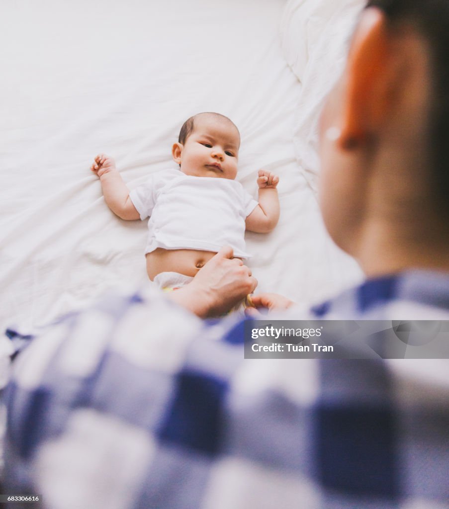 Mother changing baby girl