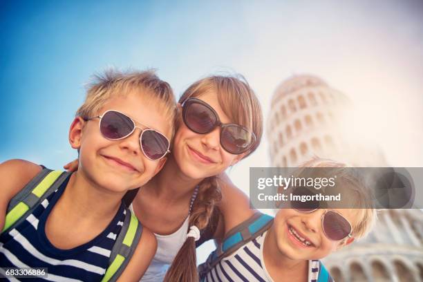 brothers and sister having fun in pisa - pisa italy stock pictures, royalty-free photos & images