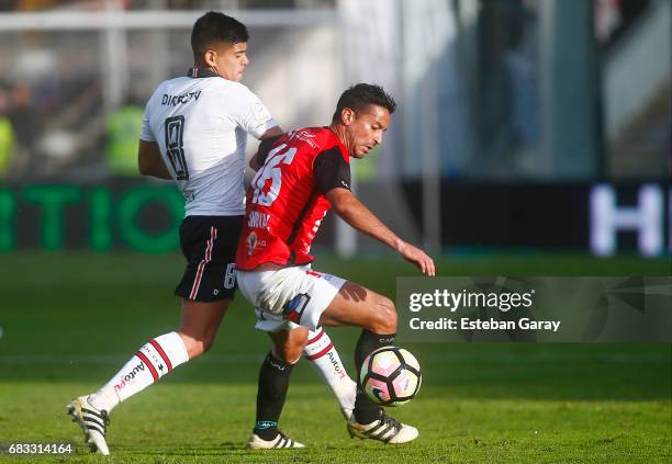 Esteban Pavez of Colo Colo struggles for the ball with Gabriel Sandoval of Antofagasta during a match between Colo Colo and Antofagasta as part of...