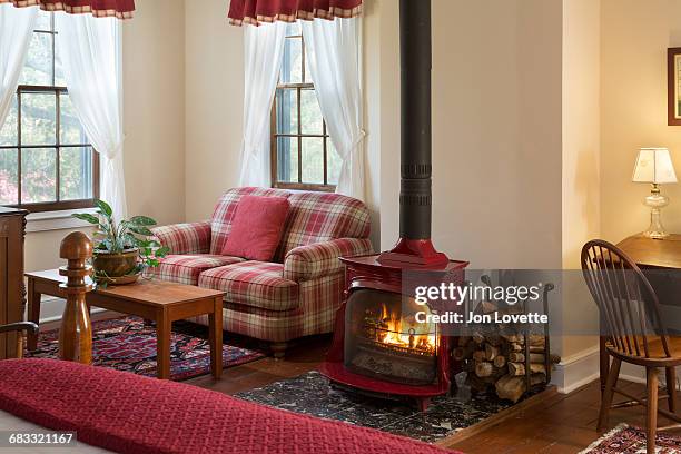 bedroom with wood burning fireplace - red plaid stock pictures, royalty-free photos & images