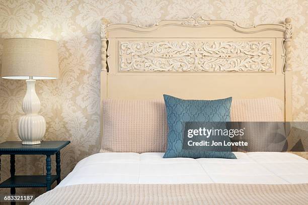 bed with painted headboard - beige bedroom stock pictures, royalty-free photos & images