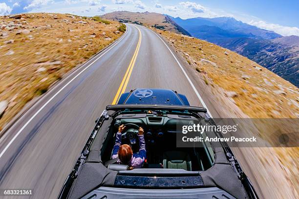 woman driving a jeep on trail ridge road - trail ridge road colorado stock-fotos und bilder