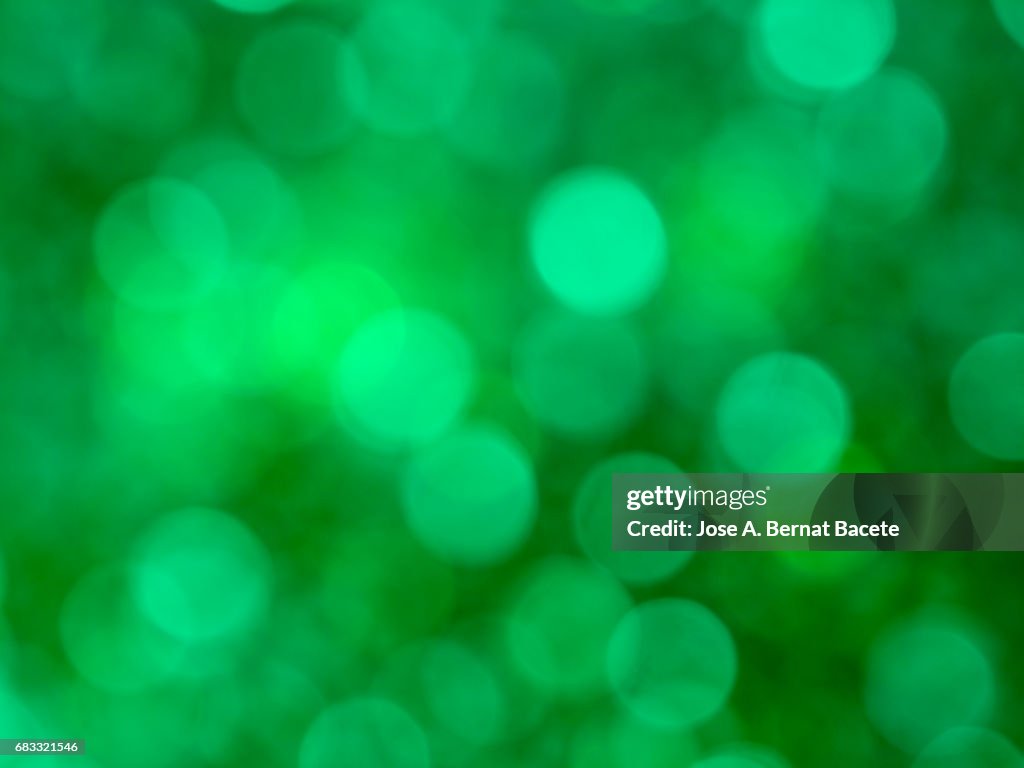 Close-up unfocused lights in the shape of circles of  green background