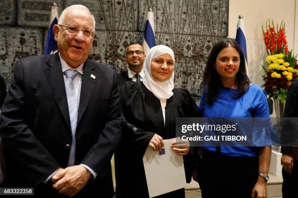 Israeli Justice Minister Ayelet Shaked and Israeli President Reuven Rivlin pose for a photo with Israeli Muslim Hana Khatib, the first woman in...