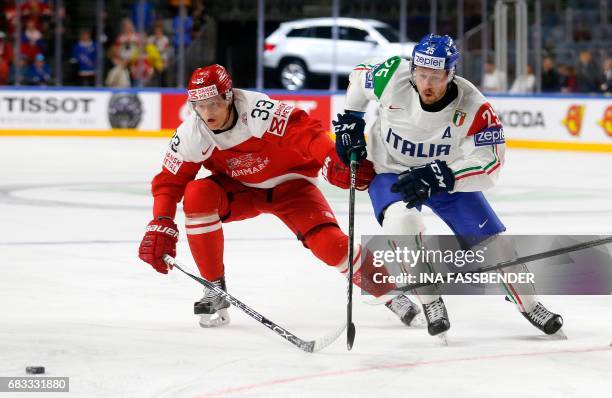 Denmark´s Julian Jakobsen and Italy´s Stefano Marchetti vie during the IIHF Men's World Championship ice hockey match between Denmark and Italy in...