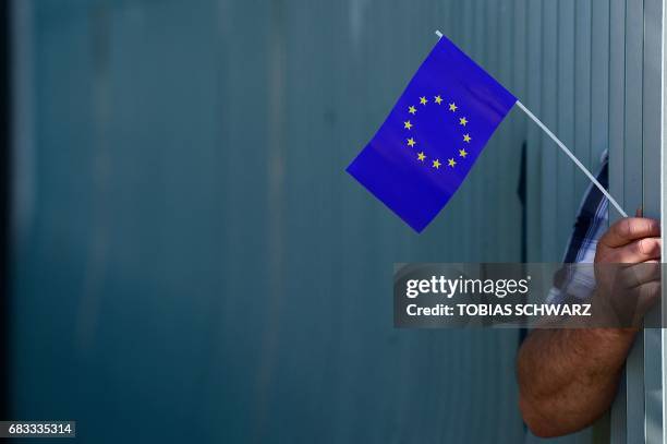 Supporters of the "Pulse of Europe" movement take part in a pro-Europe flashmob ahead of the arrival of French President Emmanuel Macron for talks on...