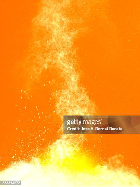 explosion of a cloud of powder of particles of colors white and yellow and a orange background - dust storm stock pictures, royalty-free photos & images