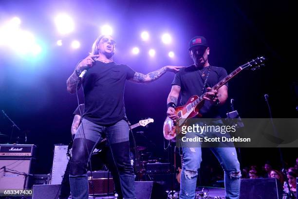 Singer Nik Frost of Bangkok Five and Dave Kushner of Velvet Revolver performs onstage during the "Strange 80's" benefit at The Fonda Theatre on May...