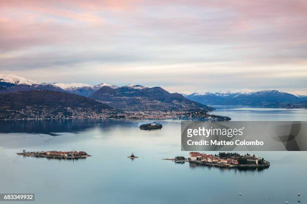 sunset over borromean islands, lake maggiore, italy - lago maggiore foto e immagini stock