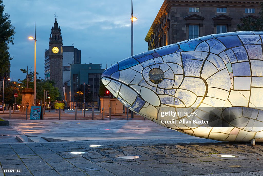 Big Fish sculpture in Belfast illuminated at dusk